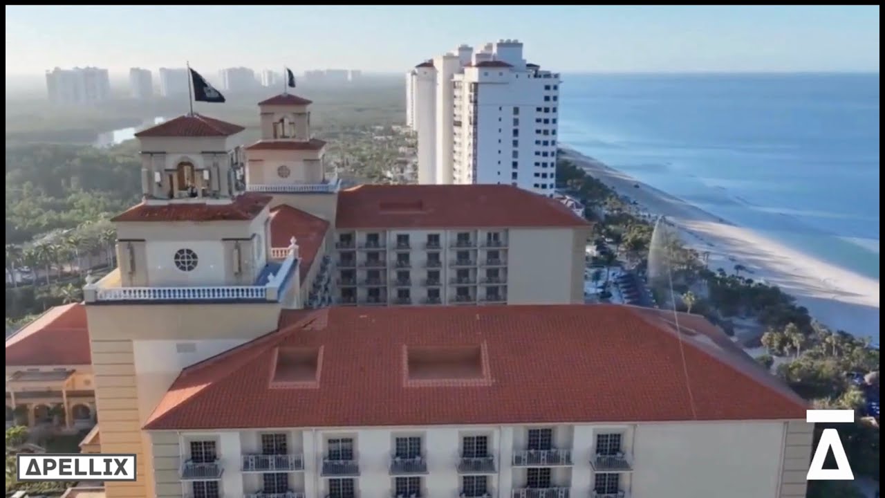 Apellix drone soft washing a roof and building exterior