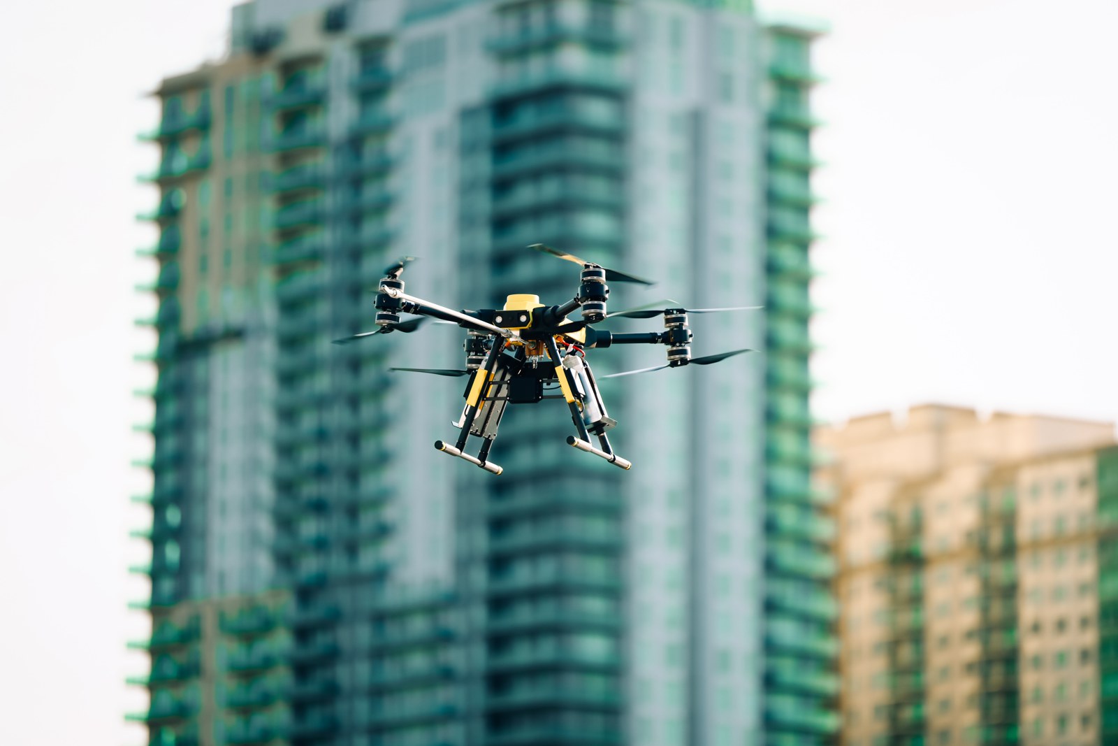 Apellix B2 drone soft washing a hotel exterior