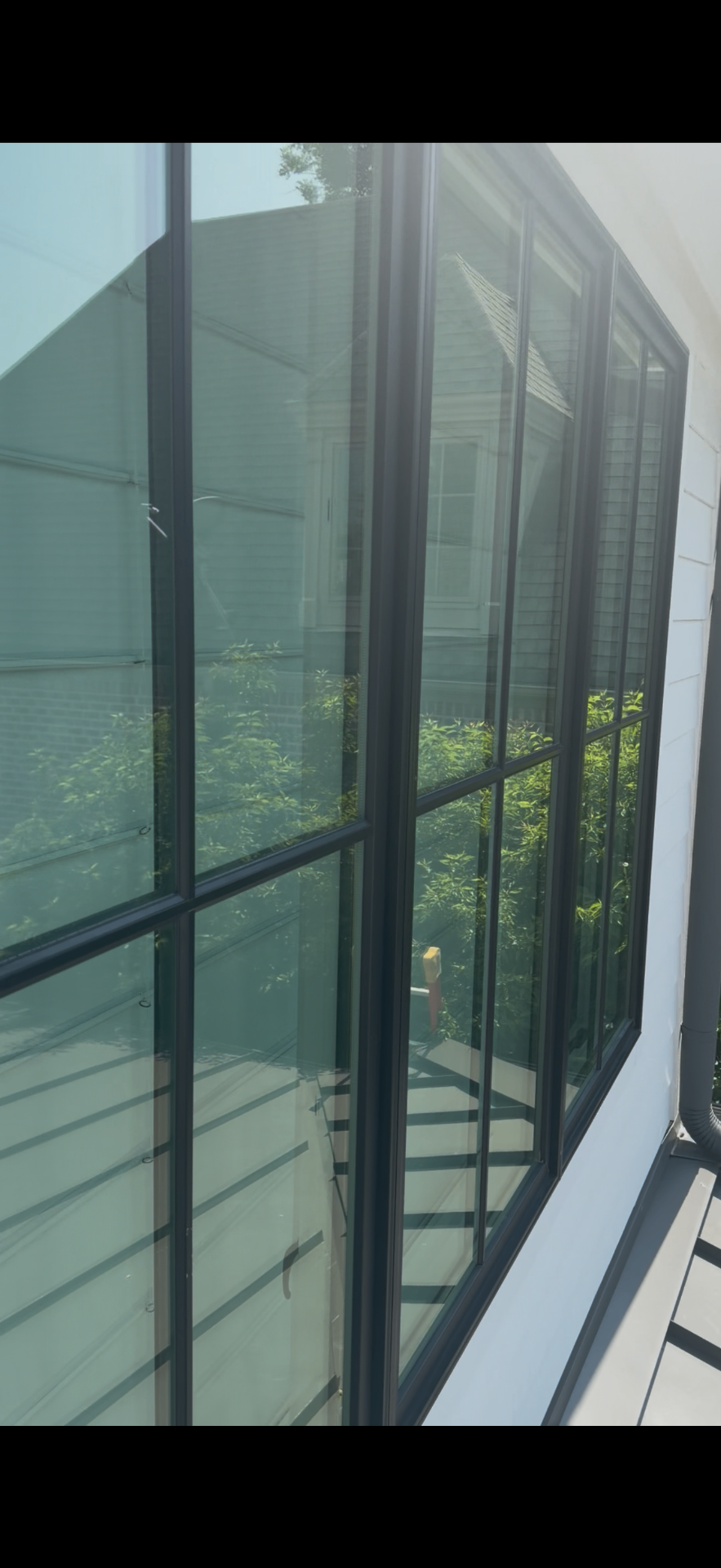 Before and after of a storefront window cleaning